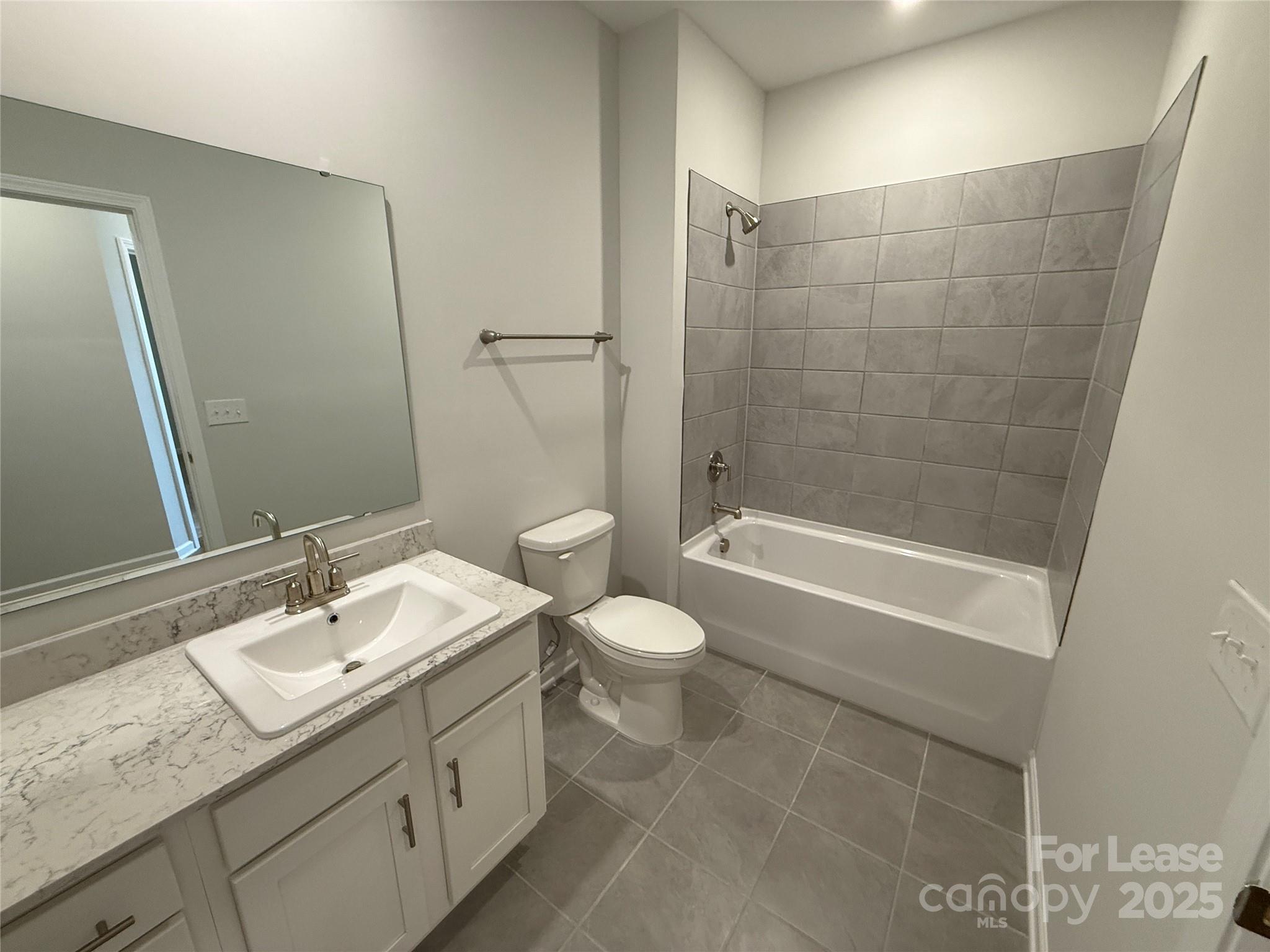 4455 Reed Crk Drive, Unit 101 Sherrills Ford, NC 28673 - Photo 20 of 34 a bathroom with a granite countertop sink a toilet and shower