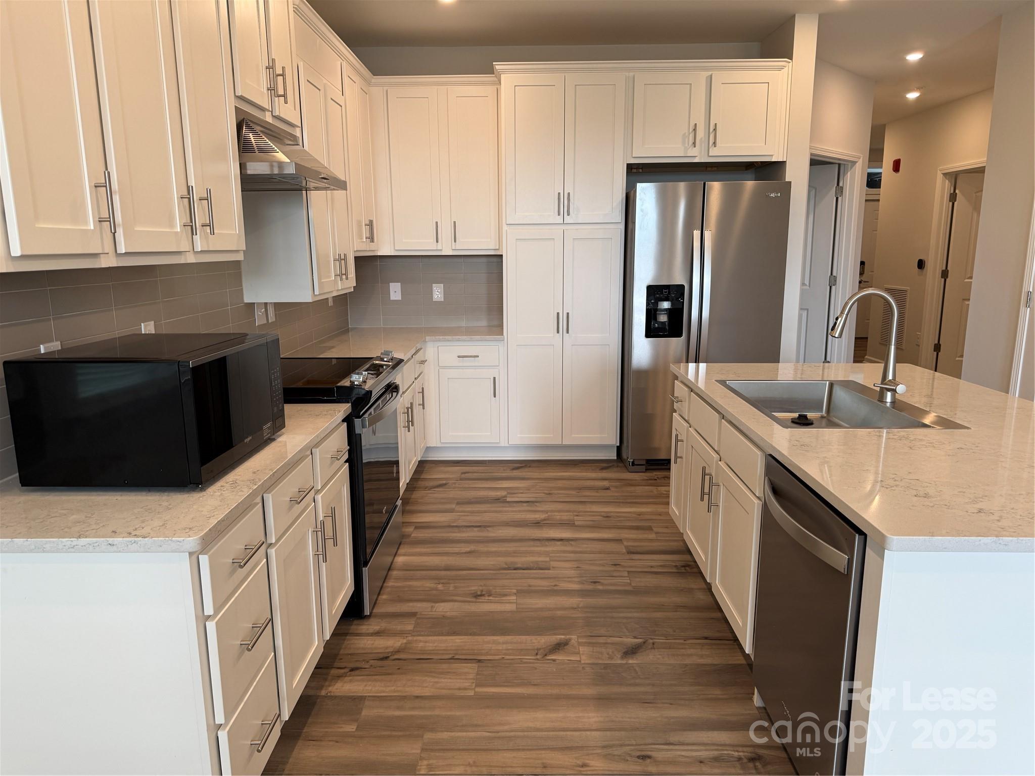 4455 Reed Crk Drive, Unit 101 Sherrills Ford, NC 28673 - Photo 6 of 34 a kitchen with stainless steel appliances a sink stove refrigerator and cabinets