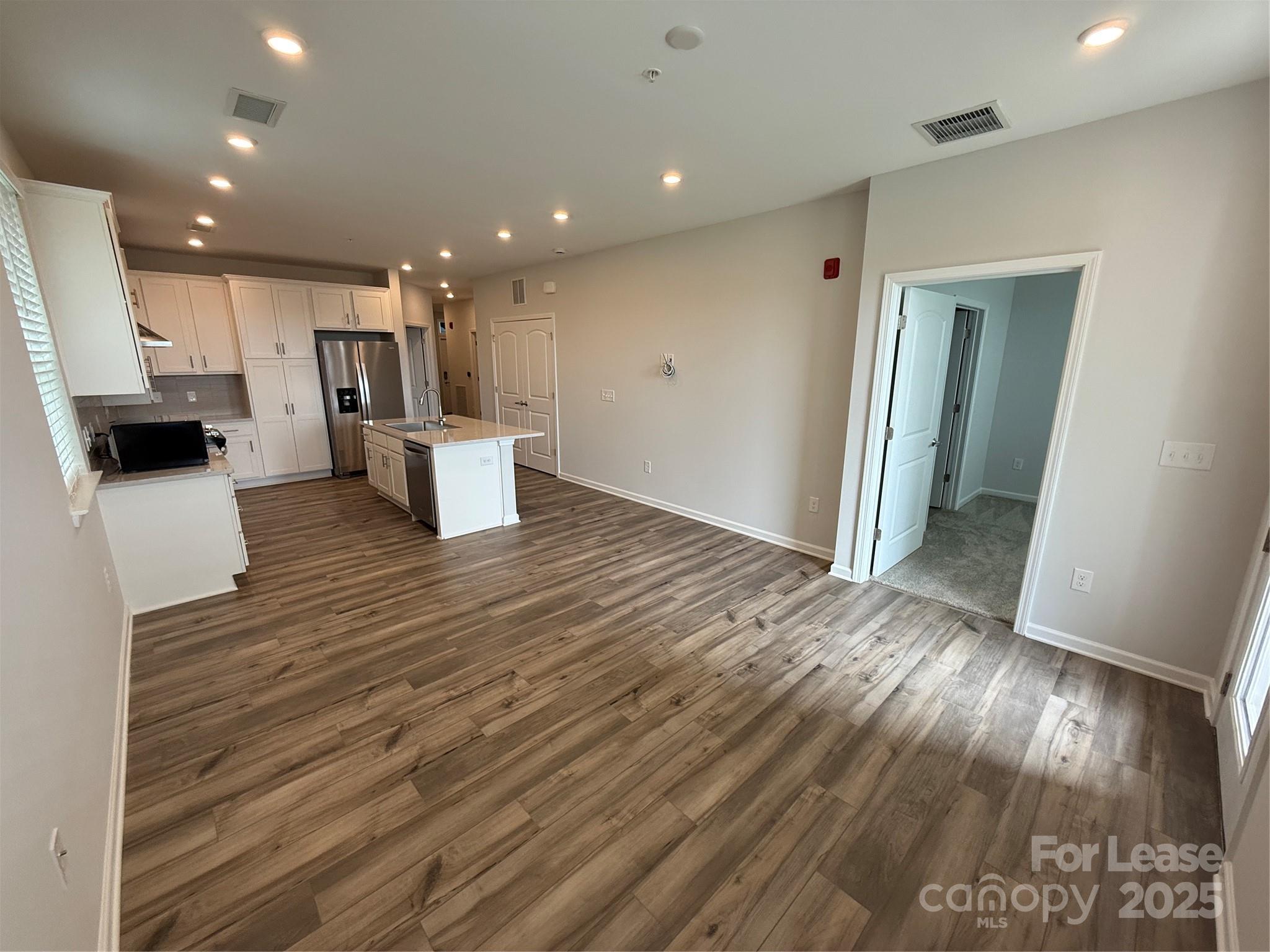 4455 Reed Crk Drive, Unit 101 Sherrills Ford, NC 28673 - Photo 10 of 34 a view of a hallway with wooden floor and seating