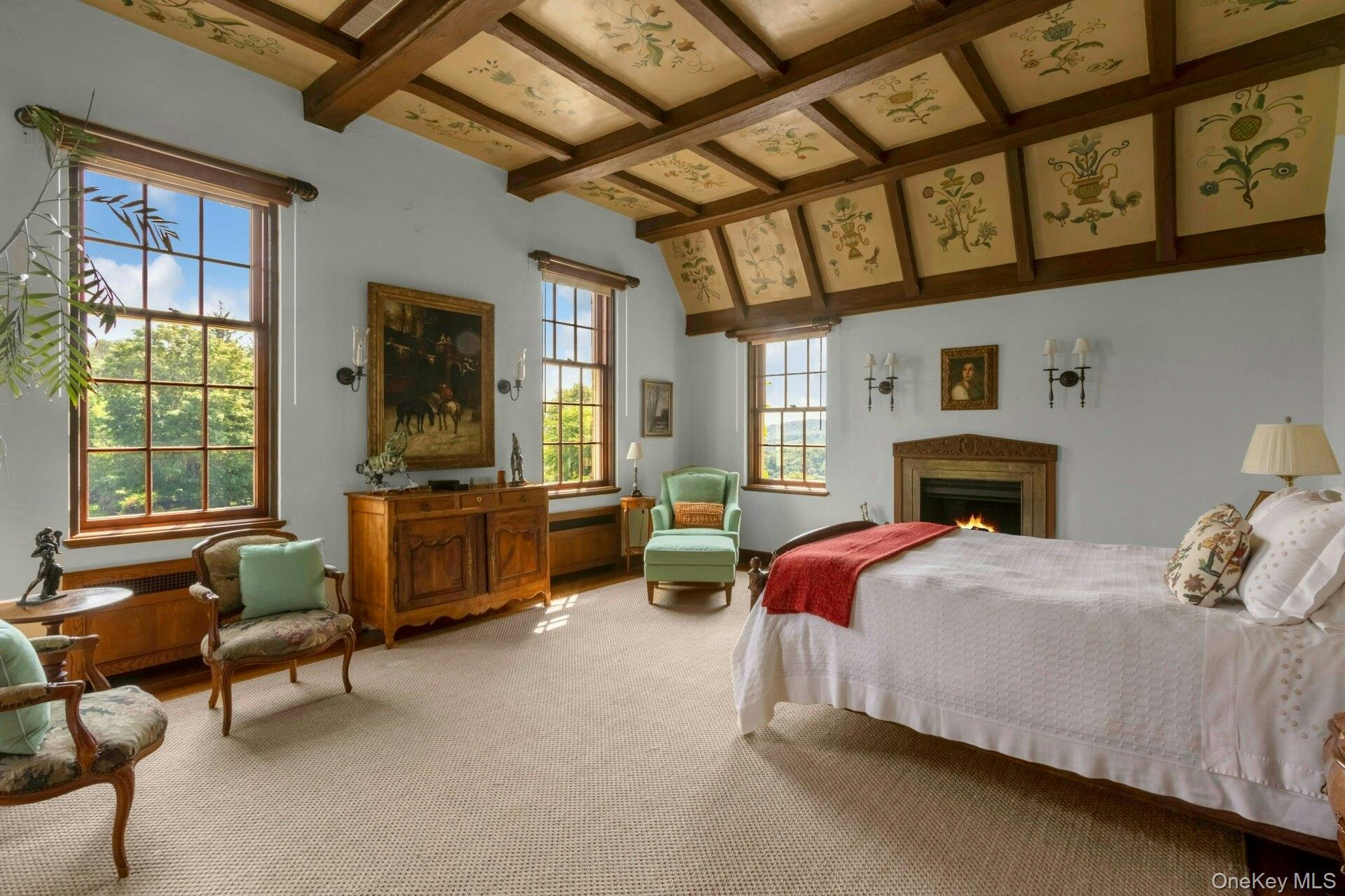 120 Ridge Road Tuxedo Park, NY 10987 - Photo 25 of 50 Carpeted bedroom with beamed ceiling and a warm lit fireplace