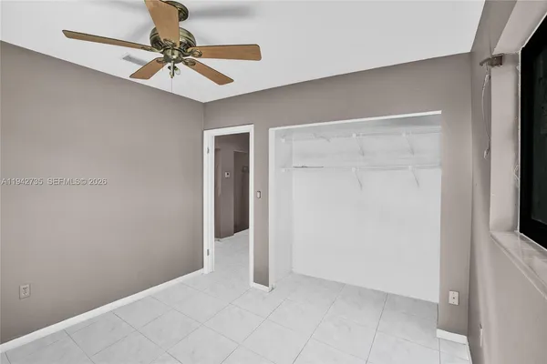 a view of a livingroom with a chandelier fan