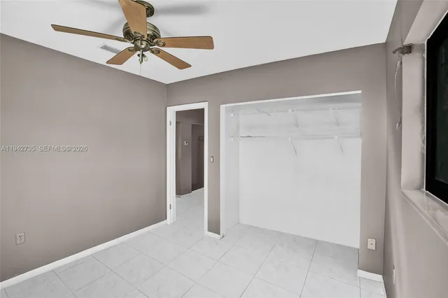 a view of a livingroom with a chandelier fan