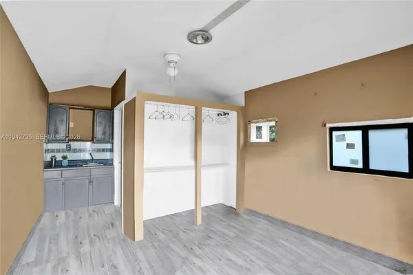 a kitchen with a refrigerator and a stove top oven