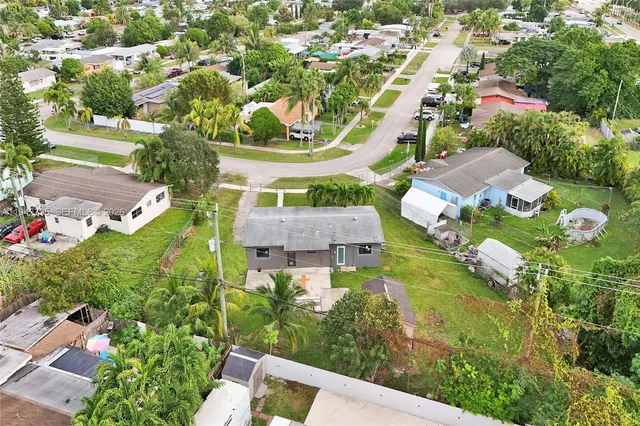 an aerial view of residential houses with outdoor space and street view