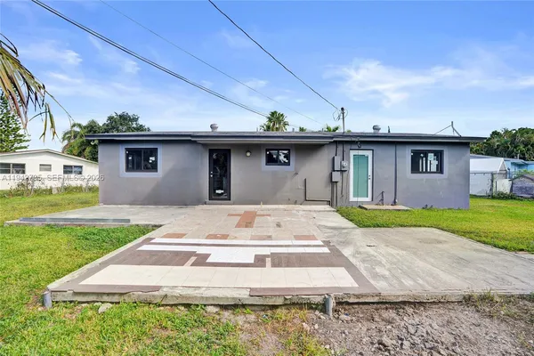 a front view of house with yard having outdoor seating