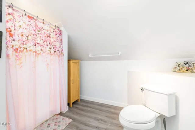 a storage room with furniture a rug and a window