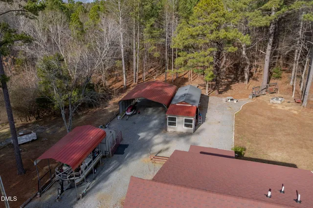 a view of a house with a yard and large tree