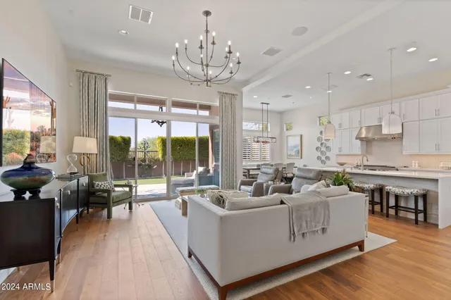 a living room with furniture and a chandelier