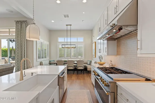 a kitchen with stainless steel appliances granite countertop a stove and a sink