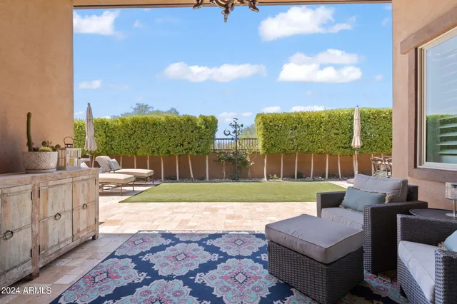a view of a backyard with sitting area