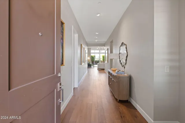 a view of a hallway with wooden floor and staircase