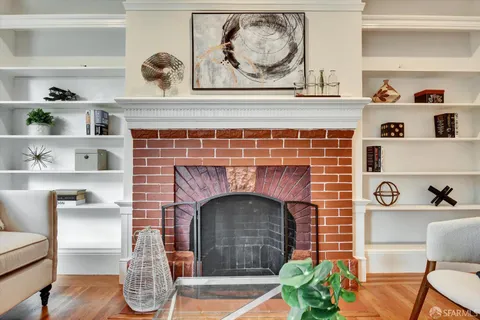 a hallway with fireplace and wooden floor