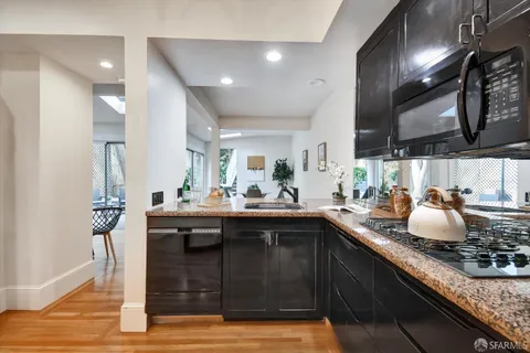 a kitchen with sink stove and cabinets