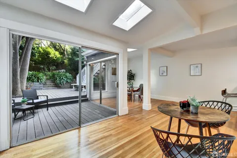 a view of a dining room with furniture window and wooden floor