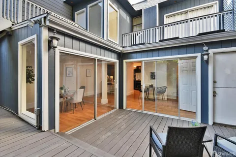 a view of a patio with table and chairs