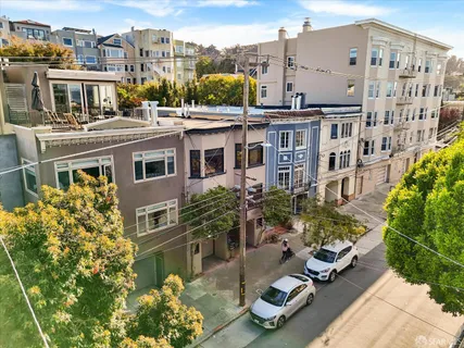 a view of a building with garden space and sitting area