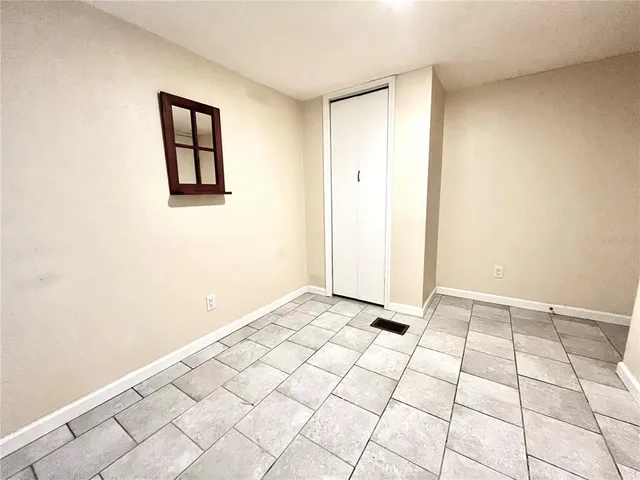 a utility room with wooden floor washer and dryer