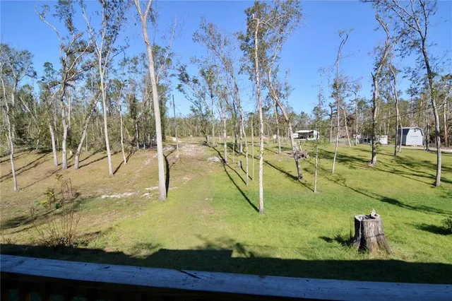 a view of a backyard with sitting area