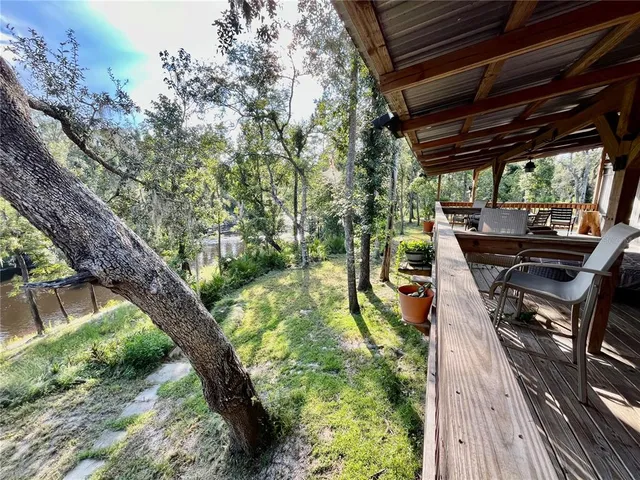 a view of a balcony with wooden floor and door