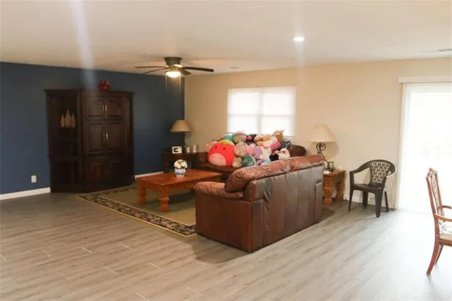 a living room with furniture and wooden floor