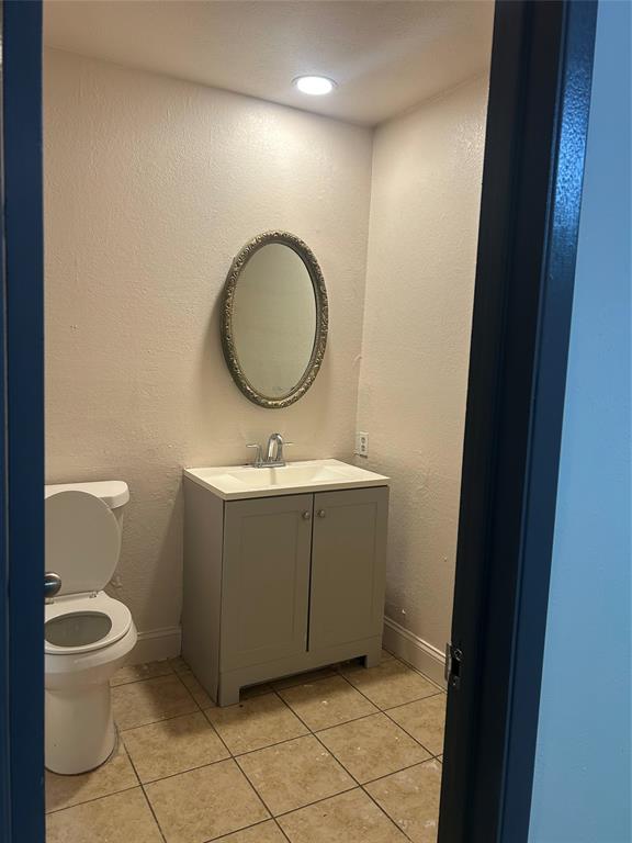 2043 Chestnut Road Carrollton, TX 75007 - Photo 17 of 19 a bathroom with a toilet mirror vanity and a sink