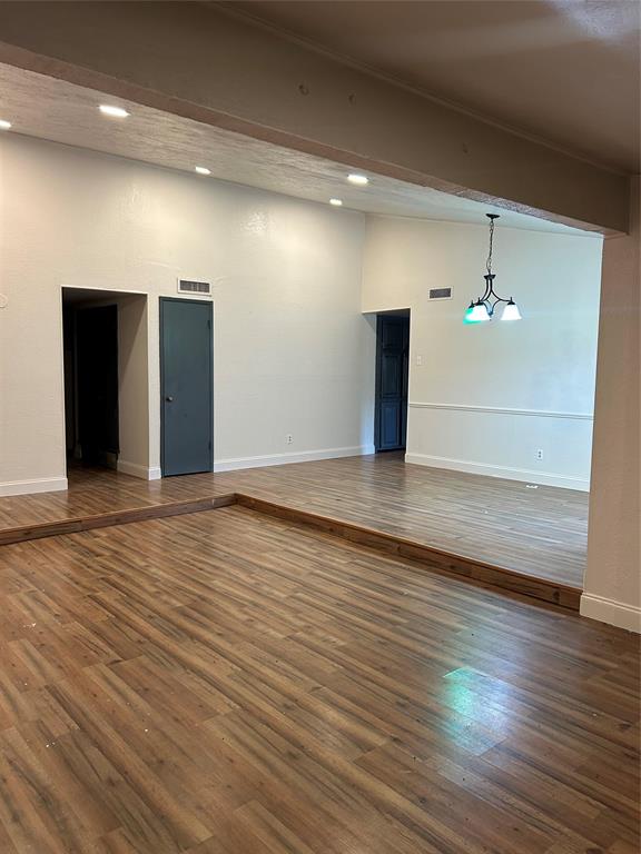 2043 Chestnut Road Carrollton, TX 75007 - Photo 6 of 19 a view of an empty room with wooden floor