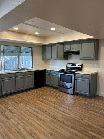 a kitchen with stainless steel appliances wooden cabinets and a counter top space