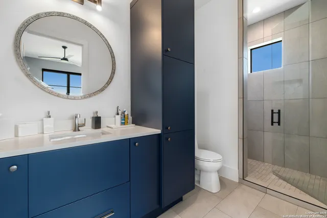 a bathroom with a toilet a sink and mirror