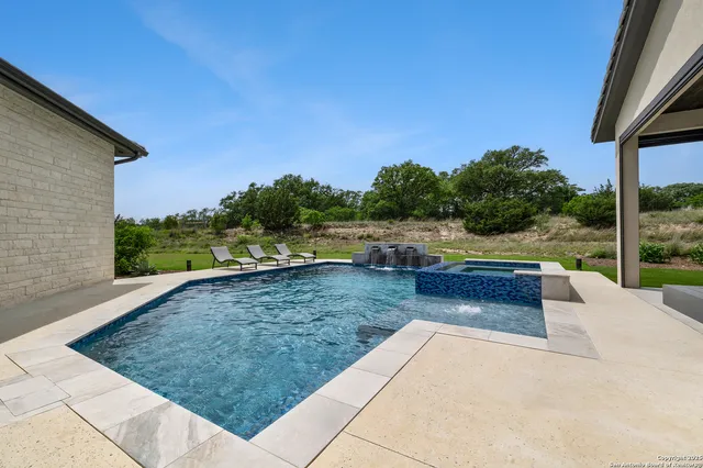 a view of swimming pool with a lounge chair