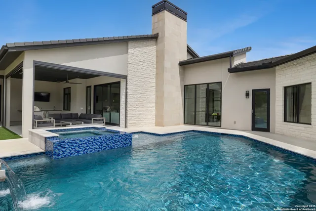 a view of a house with backyard tub and fire pit