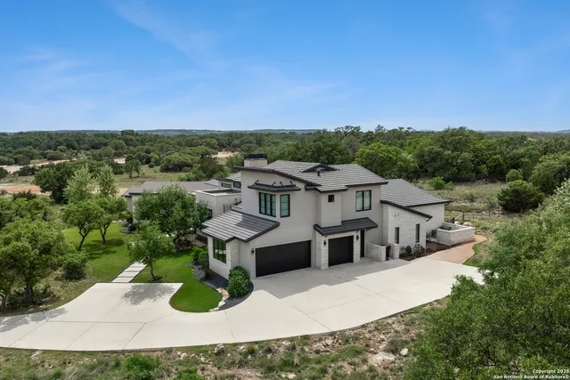 an aerial view of a house with a yard