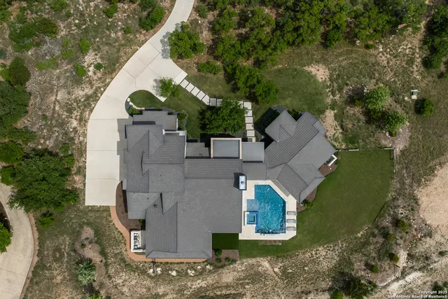 an aerial view of a house with a yard