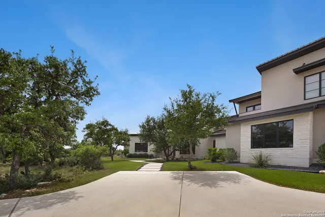 a view of a house with a yard and tree s