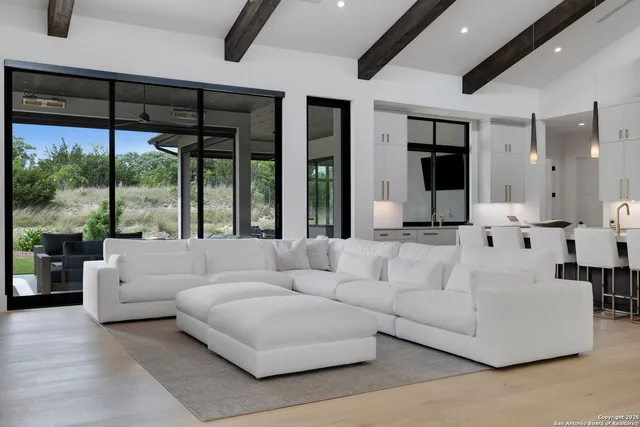 a living room with furniture and large windows