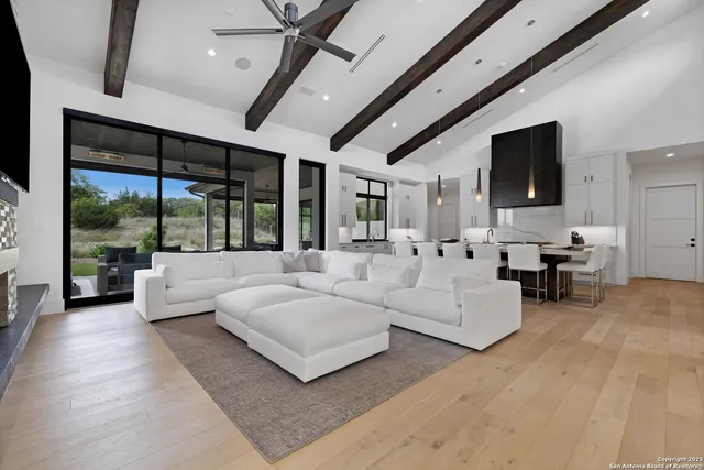 a living room with couches and a flat screen tv