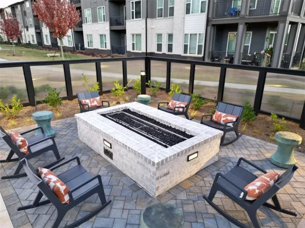 a view of a patio with a table and chairs