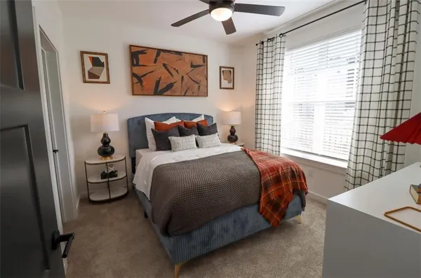 a bedroom with a bed and a large window