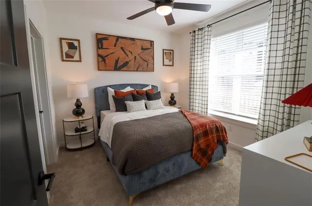 a bedroom with a bed and a large window