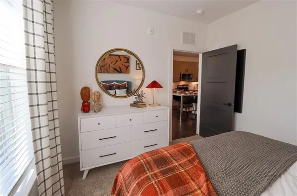 a bedroom with a bed and a dresser in it