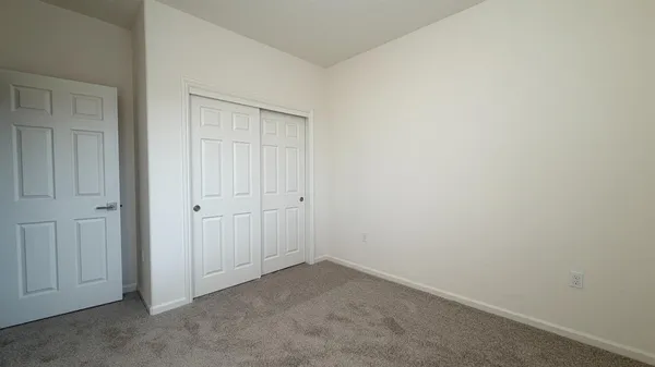 a view of hallway with wooden floor
