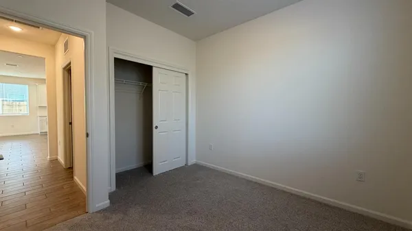 an empty room with a empty space and windows