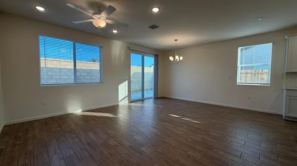 a view of kitchen with wooden floor and electronic appliances