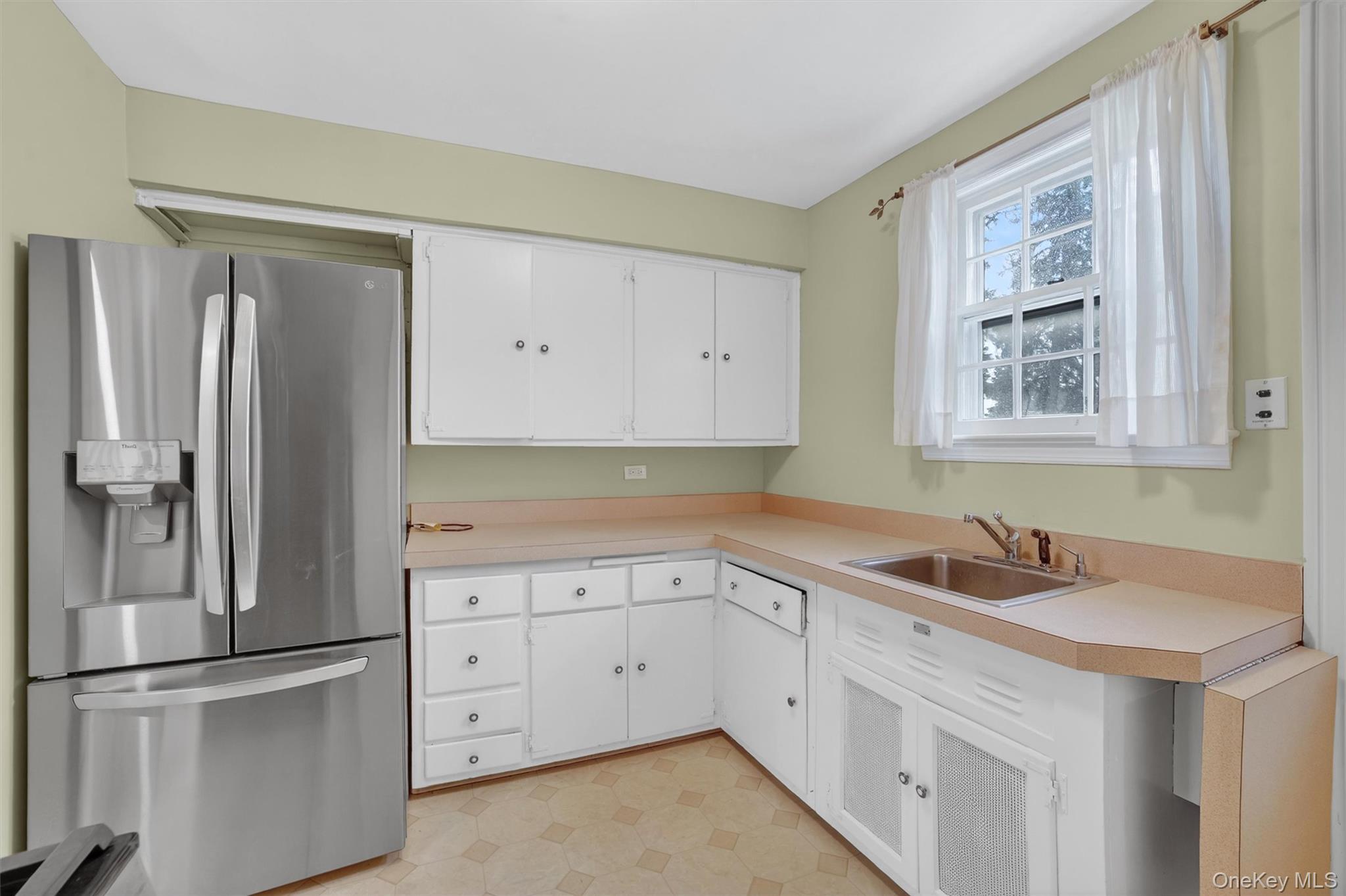 30 Argyle Road Rye Brook, NY 10573 - Photo 11 of 48 a kitchen with white cabinets and stainless steel appliances