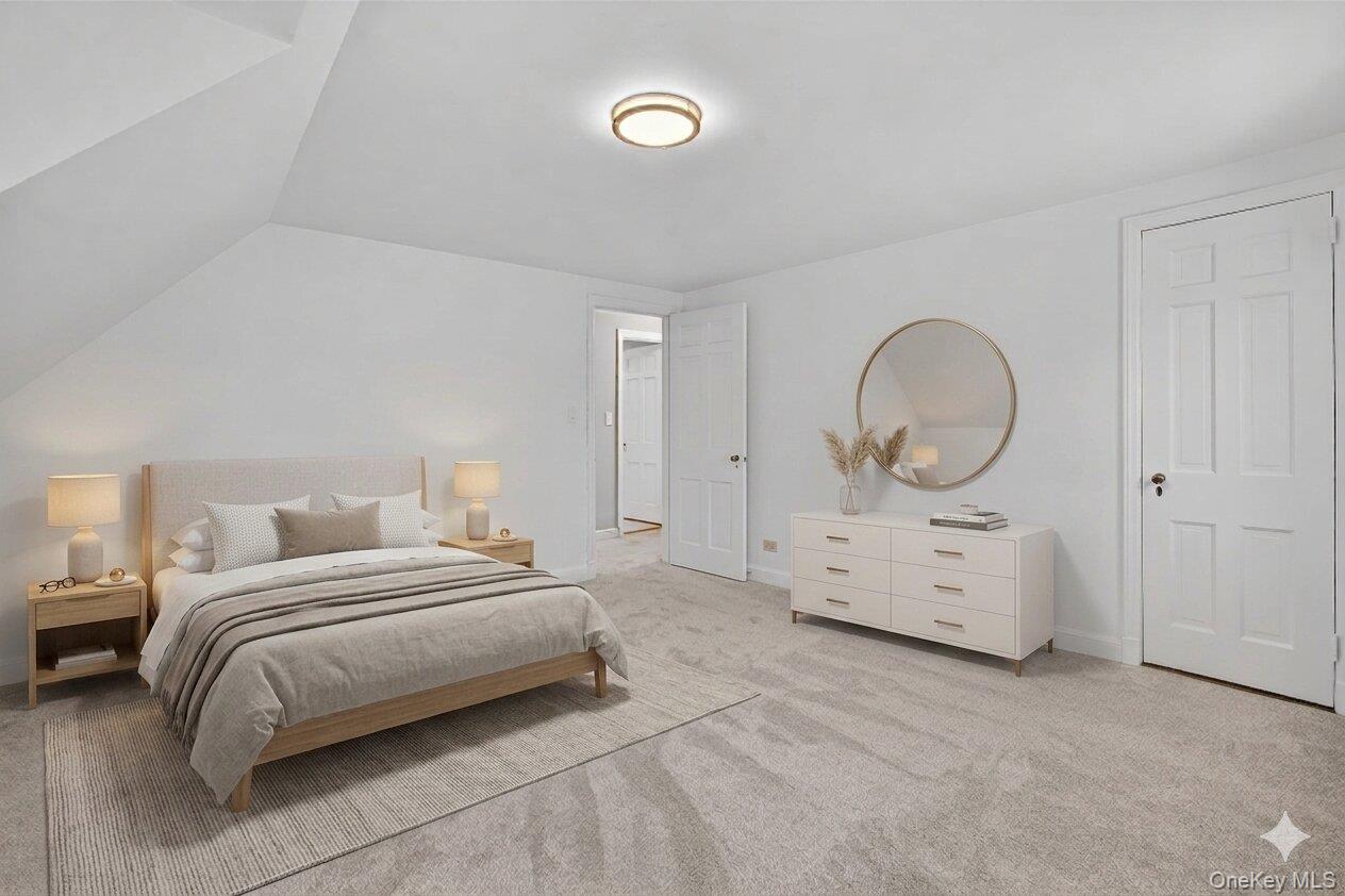 30 Argyle Road Rye Brook, NY 10573 - Photo 17 of 48 a bedroom with a bed a mirror and a chandelier