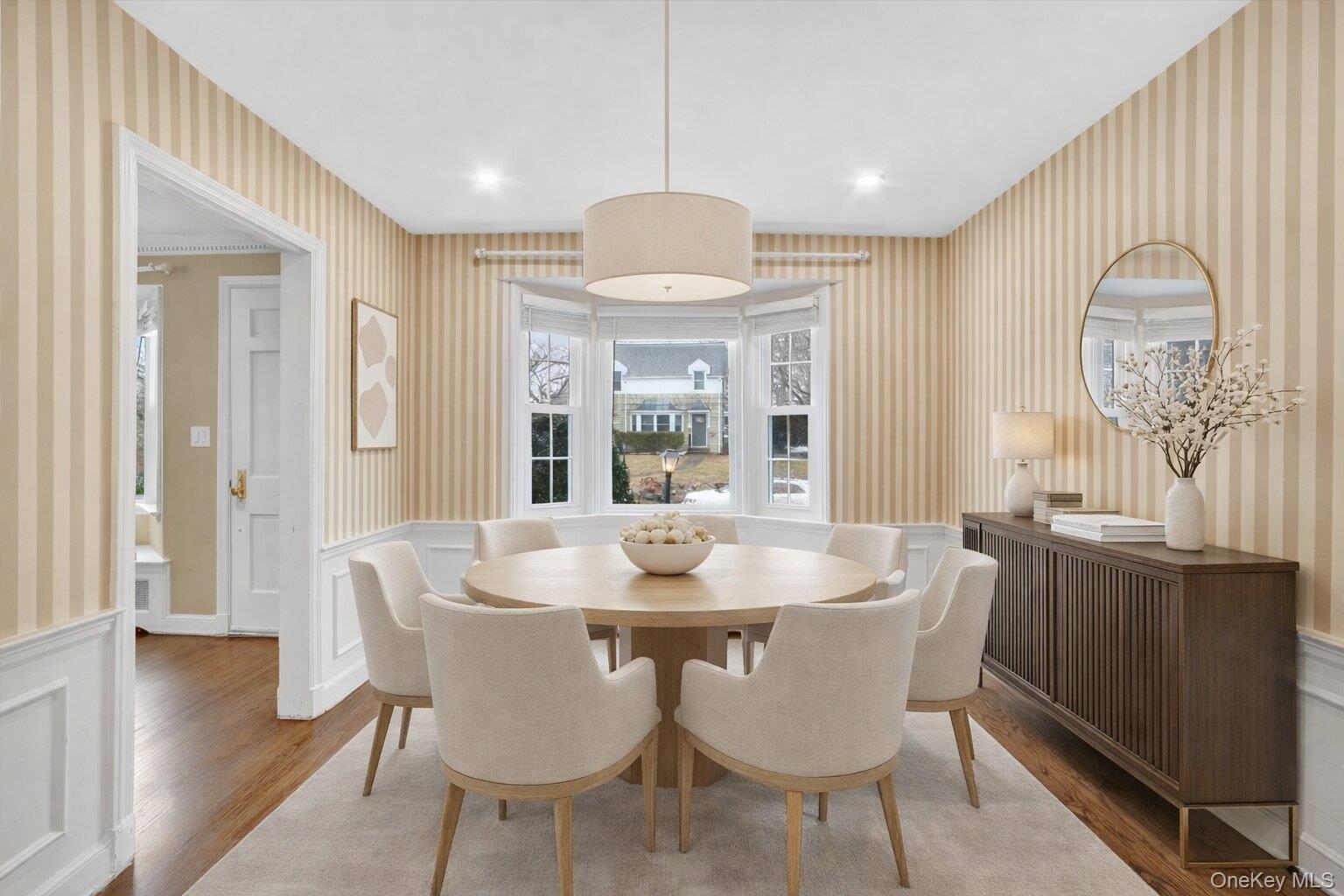 30 Argyle Road Rye Brook, NY 10573 - Photo 6 of 48 a dining room with wooden floor a chandelier a wooden table and chairs