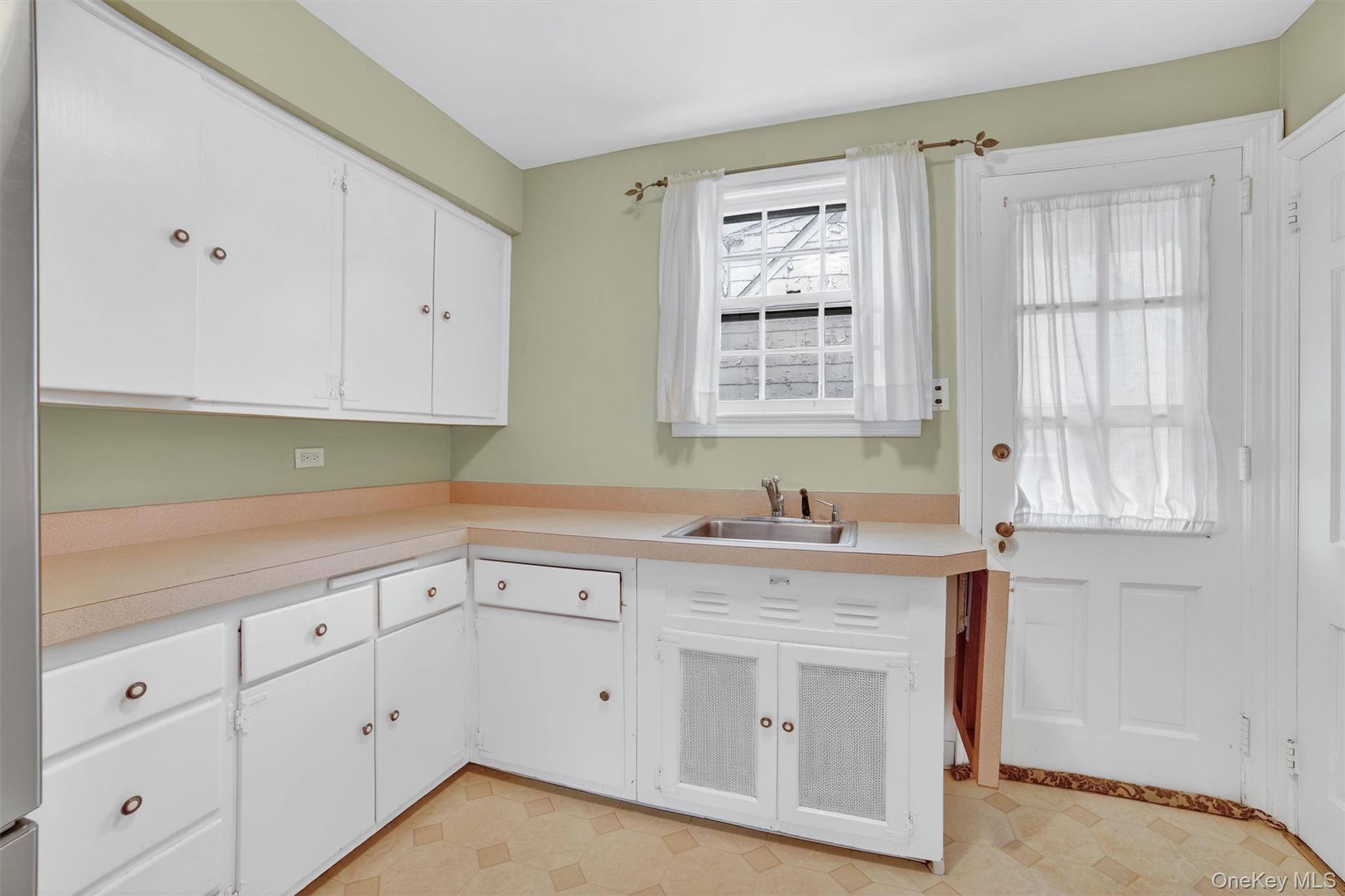 30 Argyle Road Rye Brook, NY 10573 - Photo 10 of 48 a kitchen with white cabinets white appliances and sink