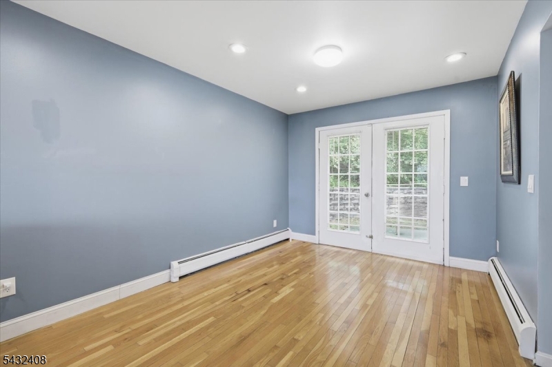 112 Knob Hill Road Hackettstown, NJ 07840 - Photo 7 of 32 a view of an empty room with wooden floor and a window