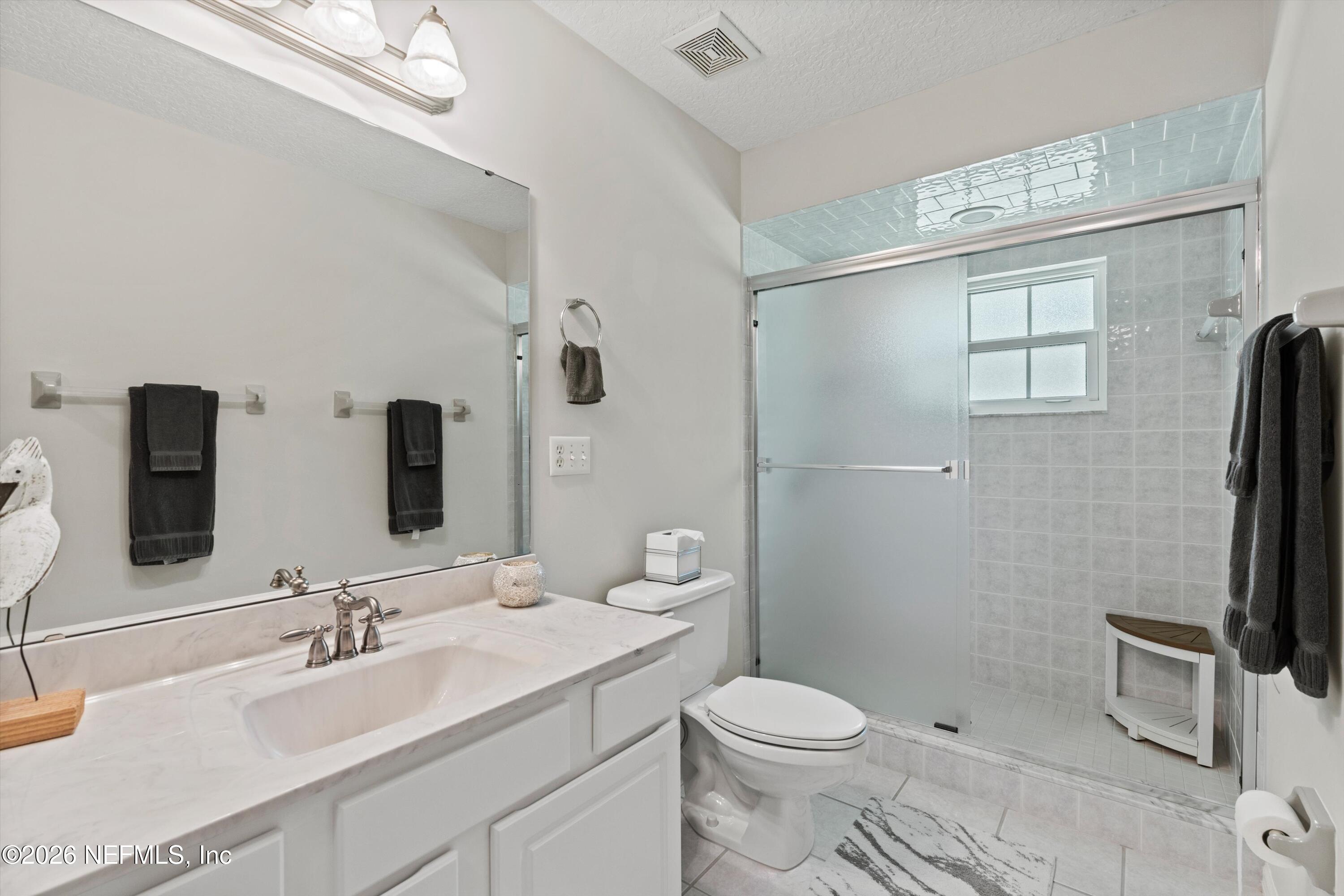 5566 Don Manuel Road Elkton, FL 32033 - Photo 25 of 47 a bathroom with a sink a toilet and mirror
