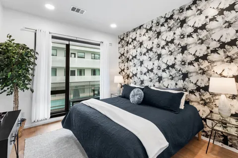 a bedroom with a bed and a potted plant