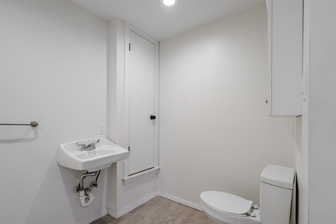2106 Lamplight Village Circle, Unit A Austin, TX 78727 - Photo 11 of 19 a bathroom with a sink a toilet and mirror